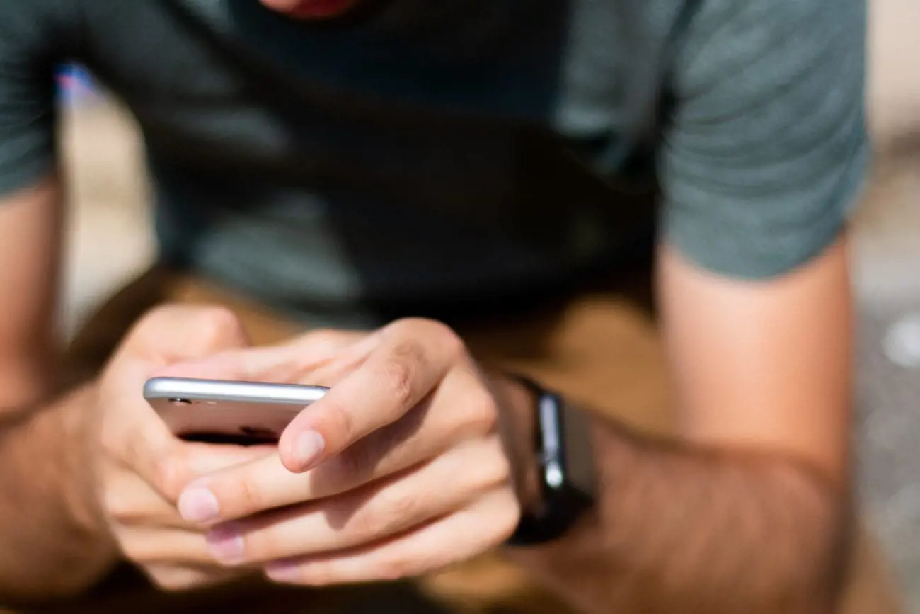 man-holding-iphone-1283371-scaled